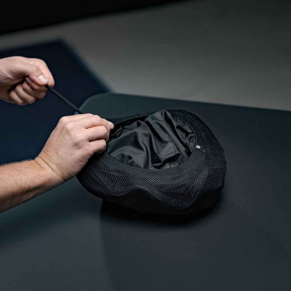 Hands cinching Beast18 into compression sack