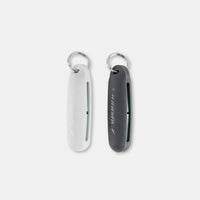 White and black silicone earplug cases laying on light gray background