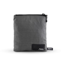 packed up charcoal poncho on white background