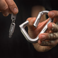 Hands on black background holding betalock and two keys