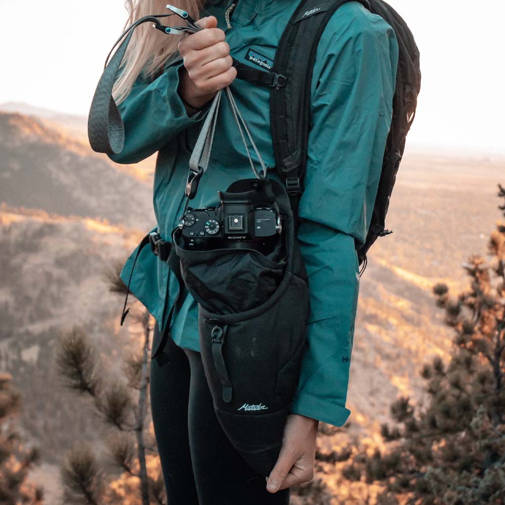 Woman taking camera out of base layer
