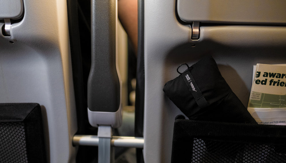 Packed up sleep mask, placed in airline seat pocket