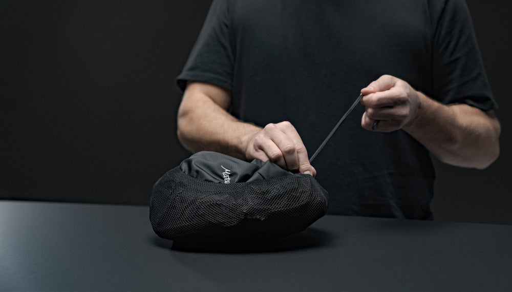 Hands cinching Beast18 into compression sack