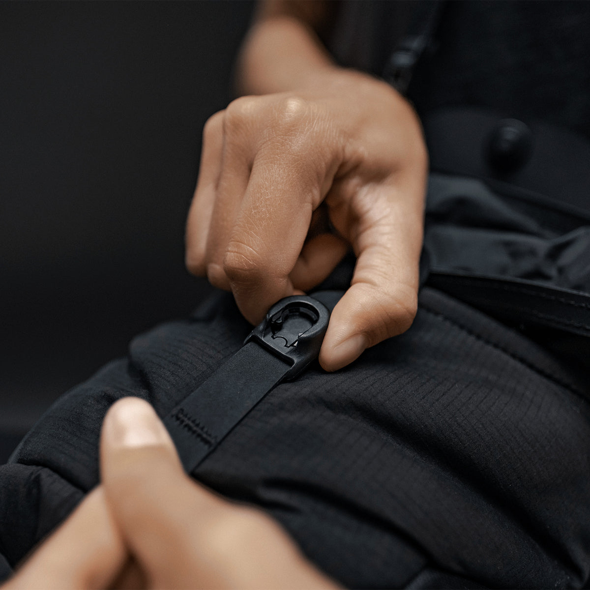 Close up view of hands holding the magnetic latch closure