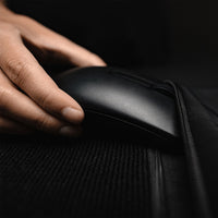 Close up view of hand putting computer mouse in zipper pocket