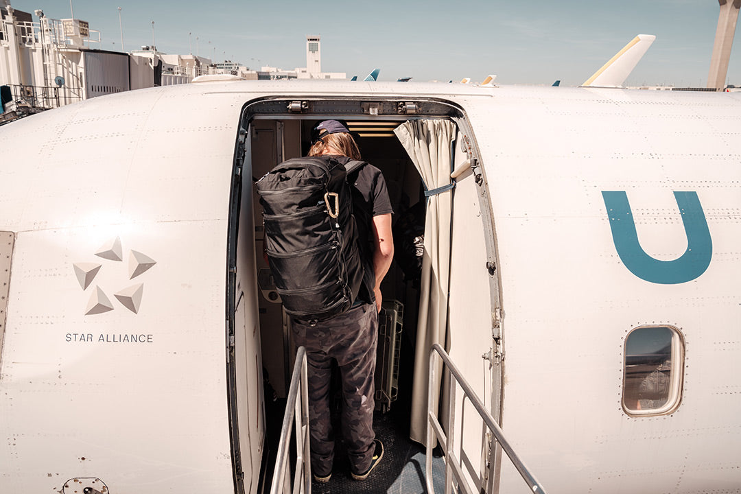 Person getting on an airplane after downloading travel apps